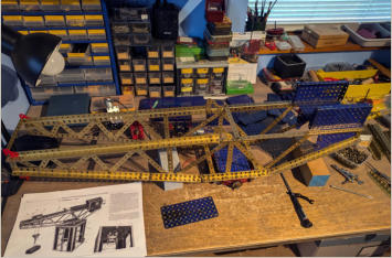 Blue and gold hammerhead crane on the bench